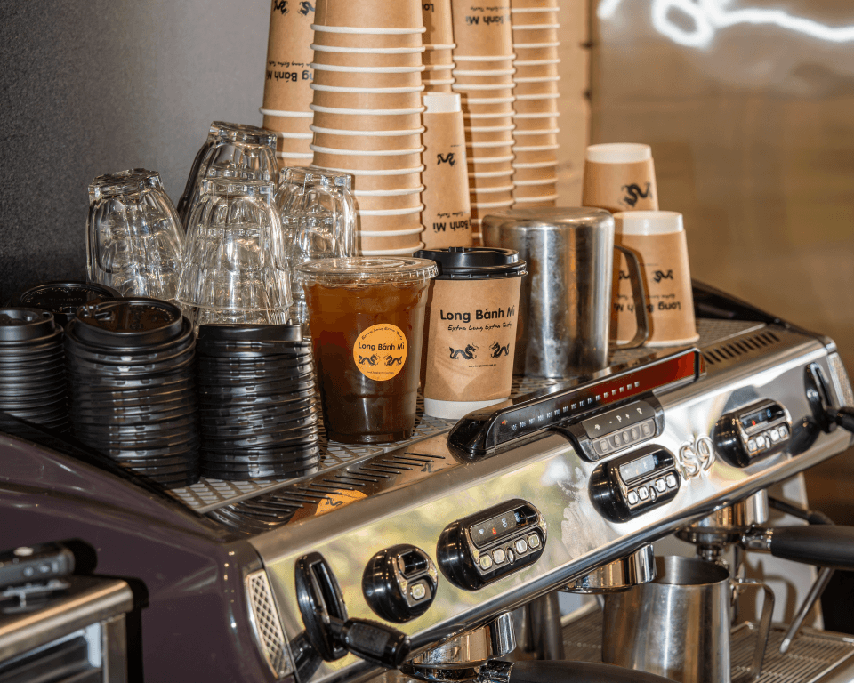 The coffee bar at Long Bánh Mì, espresso machine and cup stacks